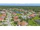 Aerial view of homes surrounding a lake in a residential area at 2388 Silver Palm Rd, North Port, FL 34288