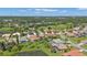 Aerial view of upscale homes, a lake, and beautifully maintained grounds at 2388 Silver Palm Rd, North Port, FL 34288
