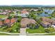 Aerial view of a luxurious home community with a lake at 2388 Silver Palm Rd, North Port, FL 34288