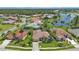 Aerial view of a neighborhood with houses and a lake at 2388 Silver Palm Rd, North Port, FL 34288
