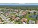 Aerial view of houses and a lake in a residential community at 2388 Silver Palm Rd, North Port, FL 34288