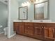Double vanity bathroom with a view into the toilet area at 2388 Silver Palm Rd, North Port, FL 34288