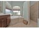 Bathroom with soaking tub, walk-in shower and window at 2388 Silver Palm Rd, North Port, FL 34288