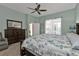 Main bedroom with king bed, dresser, and access to the bathroom at 2388 Silver Palm Rd, North Port, FL 34288