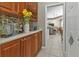Butlers pantry with wine rack and ample storage at 2388 Silver Palm Rd, North Port, FL 34288