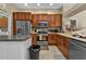 Kitchen boasts stainless steel appliances and ample wood cabinetry at 2388 Silver Palm Rd, North Port, FL 34288