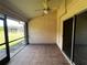 Spacious screened porch with tile flooring and ceiling fan at 25068 Harborview Rd # 1A, Punta Gorda, FL 33980