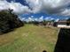 Expansive backyard view with lush lawn and screened in pool in this great community at 25068 Harborview Rd # 1A, Punta Gorda, FL 33980