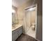 Bathroom featuring vanity and shower with updated tile and fixtures at 25068 Harborview Rd # 1A, Punta Gorda, FL 33980