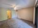 Carpeted bedroom featuring ceiling fan and access to bathroom at 25068 Harborview Rd # 1A, Punta Gorda, FL 33980