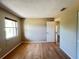 Cozy bedroom featuring wood floors and a window for natural light at 25068 Harborview Rd # 1A, Punta Gorda, FL 33980
