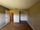 Bedroom features closet space, hard wood floors and neutral colored walls at 25068 Harborview Rd # 1A, Punta Gorda, FL 33980