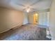 Carpeted bedroom features ceiling fan and access to bathroom and closet space at 25068 Harborview Rd # 1A, Punta Gorda, FL 33980