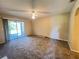 Cozy bedroom boasts a ceiling fan, access to the outdoor space through glass sliders, and new carpet at 25068 Harborview Rd # 1A, Punta Gorda, FL 33980