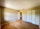 Inviting bedroom features wood floors and a closet with double doors at 25068 Harborview Rd # 1A, Punta Gorda, FL 33980