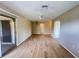 Bright living room with wood-look floors, ceiling fan, and sliding glass door at 25068 Harborview Rd # 1A, Punta Gorda, FL 33980