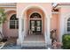 Inviting house entrance with double doors, arched windows, and a tiled porch at 2507 Via Veneto Dr, Punta Gorda, FL 33950