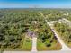 Aerial view of single-Gathering home with solar panels and pool, situated on a large lot at 3081 Collingswood Blvd, Port Charlotte, FL 33948