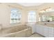 Bathroom with a large soaking tub, double vanity, and separate shower at 3081 Collingswood Blvd, Port Charlotte, FL 33948