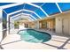 Relaxing kidney-shaped pool with screened enclosure at 3081 Collingswood Blvd, Port Charlotte, FL 33948