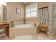 Elegant bathroom featuring a corner soaking tub and walk-in shower at 3322 Sandpiper Dr, Punta Gorda, FL 33950