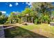 Serene backyard featuring mature trees, a charming gazebo, outdoor kitchen and a tranquil hammock at 3646 Madagascar Ave, North Port, FL 34286