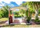 Relaxing backyard with a covered seating area and lush tropical landscaping at 3646 Madagascar Ave, North Port, FL 34286
