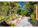 A lush garden featuring a small concrete walk and tropical foliage at 3646 Madagascar Ave, North Port, FL 34286