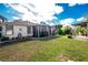 Screened porch and lawn with landscaping and a gazebo at 3646 Madagascar Ave, North Port, FL 34286