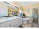 Bathroom features a double sink vanity, tub, and glass-enclosed shower at 3646 Madagascar Ave, North Port, FL 34286