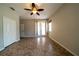Spacious bedroom with ceiling fan, tile floors, and a private patio at 3646 Madagascar Ave, North Port, FL 34286