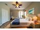 This is a staged bedroom featuring a ceiling fan, wood floors, and a large window for natural light at 3646 Madagascar Ave, North Port, FL 34286