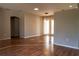 Large empty room, featuring a mixed tile and hardwood flooring at 3646 Madagascar Ave, North Port, FL 34286