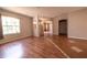 An empty, unfurnished room with tile and hardwood floors and an archway at 3646 Madagascar Ave, North Port, FL 34286