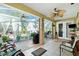 Enclosed patio with ceiling fans, tile floors, and views of the landscaped yard at 3646 Madagascar Ave, North Port, FL 34286