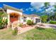 Charming home with a pink facade, columns at the entrance, and a well-maintained lawn at 3646 Madagascar Ave, North Port, FL 34286