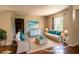 Inviting living room with natural light and comfortable wicker furniture at 3646 Madagascar Ave, North Port, FL 34286
