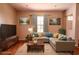 Well-lit living room with a comfortable sectional sofa and warm, inviting decor at 3646 Madagascar Ave, North Port, FL 34286