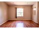 Cozy living room with hardwood floors and a large window for natural light at 3646 Madagascar Ave, North Port, FL 34286