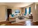 Staged living room with tile and wood floors, featuring cream couches and modern decorations at 3646 Madagascar Ave, North Port, FL 34286