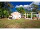 Backyard shed in a spacious yard with landscaping and a pergola at 3646 Madagascar Ave, North Port, FL 34286