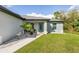 House exterior showcasing walkway, teal door, and landscaping at 4340 Adolph Ave, North Port, FL 34288