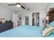 Bright bedroom with large bed, dresser, and view into bathroom and kitchen at 4340 Adolph Ave, North Port, FL 34288