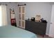 This bedroom has a dresser, a ladder-style blanket rack, and sliding closet doors with glass pane inserts at 4340 Adolph Ave, North Port, FL 34288
