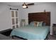 Bedroom featuring barn door style closet, ceiling fan and decorative headboard with built-in display shelving at 4340 Adolph Ave, North Port, FL 34288