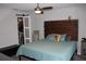 Bright bedroom featuring a queen bed, modern ceiling fan, and sliding barn door closet for convenient storage at 4340 Adolph Ave, North Port, FL 34288