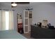 Bedroom with barn door style closet, hanging curtains, and decorative dresser featuring a picture frame and clock at 4340 Adolph Ave, North Port, FL 34288