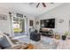 Living room with gray sectional sofa, large TV, and sliding glass doors to backyard at 4340 Adolph Ave, North Port, FL 34288