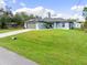 Charming single-story house with a green lawn and driveway at 4340 Adolph Ave, North Port, FL 34288