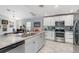 Modern kitchen with stainless steel appliances, granite countertops, and breakfast bar at 4340 Adolph Ave, North Port, FL 34288